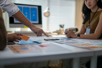 One person is pointing at a card on the table