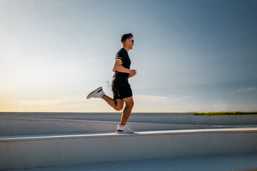 Jogging at sunrise along a minimalist pathway in a serene setting