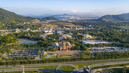 Drone view of Beto Carrero World theme park with surrounding landscape and distant city skyline.default © Marcio Eneas