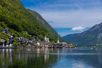 Fototapeta premium Hallstatt village in Austria on the shore of alpine lake. Historic village and mountain landscape. Traditional architecture scenic waterfront and natural surroundings popular tourist destination