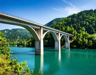 Scenic bridge over turquoise lake, lush green hills