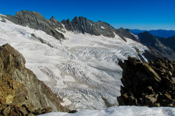 Obraz premium Alps mountains snow ridges view of Monte Rosa massive. Lyskamm, Pollux and Castor summits above the clouds stunning landscape mountains view. Alps high attitude extreme terrain climbing and glacier