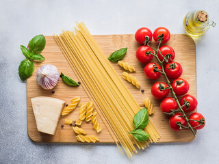 Overhead Flat Lay: Fresh Pasta Ingredients with Ripe Cherry Tomatoes and Basil Leaves

