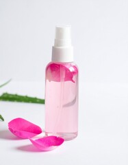 Refreshing rose water spray with petals and aloe vera for natural skincare and beauty.