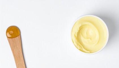 Luxurious creamy balm in tub with wooden applicator for skin care and spa treatments