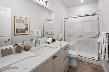 Bathroom with a white toilet, sink, and shower