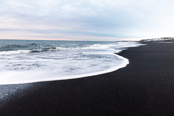 Impression of the black lava beaches near Solheimasandur along the icelandic south coast in Winter