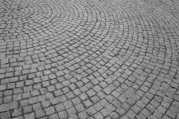 stone pavement in perspective Stone pavement texture in perspective. Abstract round background of old cobblestone pavement. Abstract backdrop of old historical cobbled stone pavement close-up.