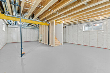 Large empty room with a staircase in the middle