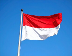 The Indonesian flag waves proudly against a clear, bright blue sky.