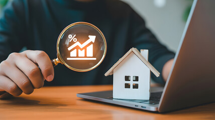 Explore rising real estate trends and investment opportunities with a magnifying glass, house model, and laptop, perfect for financial growth concepts