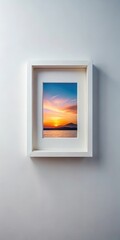 Simple frame on a minimalist wall holding a single small framed picture of a serene landscape at sunset
