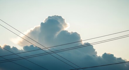 Fototapeta premium A large cloud formation with visible power lines against a pale sky backdrop
