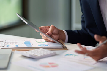Data Analysis. Business professional reviewing charts and graphs.