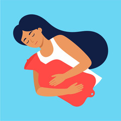 Woman embraces a red hot water bottle with a serene expression for warmth and comfort, set against a soothing light blue background.