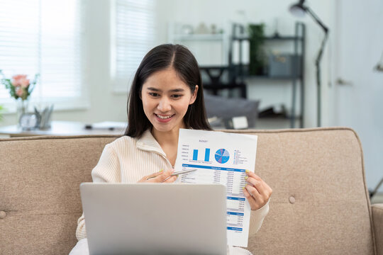 Remote Work and Data Presentation. Young woman presenting financial data during a video call.