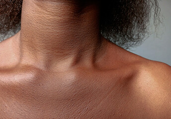 Front view of African woman neck and collarbone. Close up of hollow or deep neckline of brown skin female.