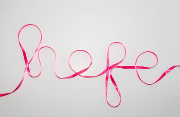 The word Hope spelled out in pink ribbon