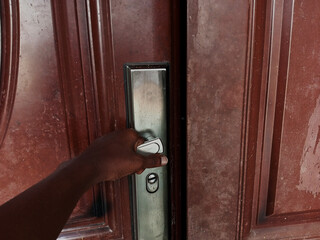 Human hand opening a door