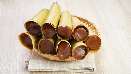 Clorot, Indonesian traditional cake made from rice flour with coconut milk, wrapped in young coconut leaves in a cone shape.
