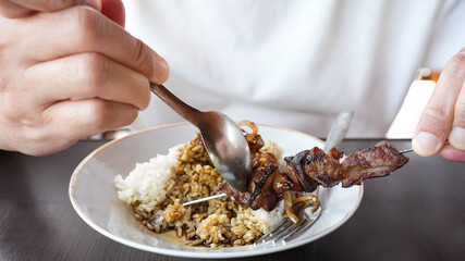 Sate Klatak, tender lamb satay skewered on bicycle spokes, served on yellow curry soup. Popular street food in Yogyakarta
