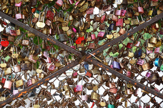 Individual padlocks of eternal ove with a romantic gesture are locked to a fence in Paris, France