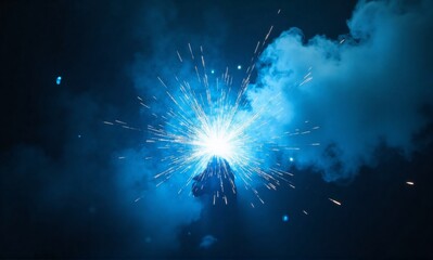 A burst of bright sparks and blue smoke illuminate the darkness, creating a dramatic, almost otherworldly scene.  The light suggests intense energy and creation.