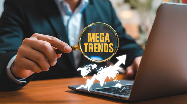 Discover mega trends for business success with data analysis using a magnifying glass and laptop, visualizing global growth and market opportunities now