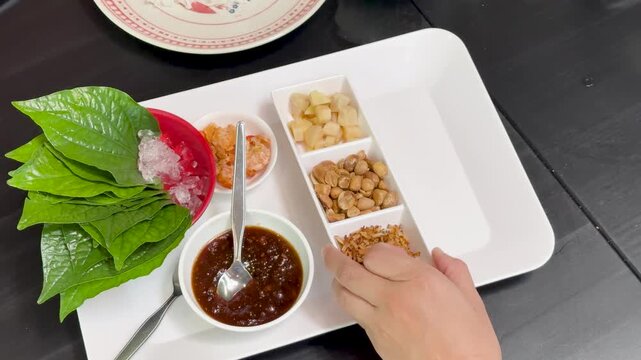 Arranging Miang Kham Ingredients on Serving Tray Overhead