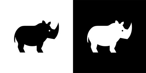 Two contrasting silhouettes of a rhinoceros, black and white, side-by-side.