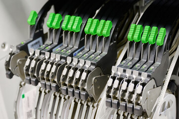 Detailed view of tape feeders in a SMT pick-and-place machine during assembly processes in a...