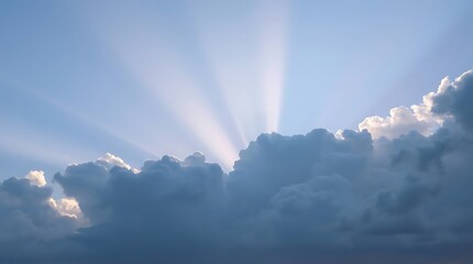 Cloudy blue sky with sun beams as background.