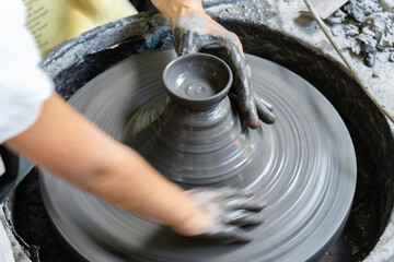 Young Artisan Shaping Clay on Pottery Wheel