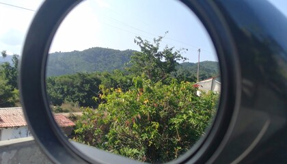 Mountain view through a car mirror