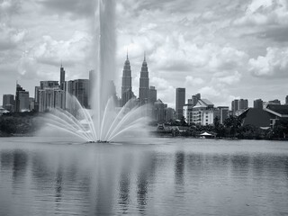 an urban park with a fountain in a megalopolis