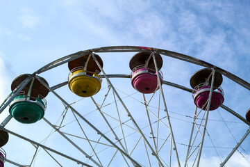 Closeup of Ferris Wheel with Colorful Passenger Cars at Amusement Park