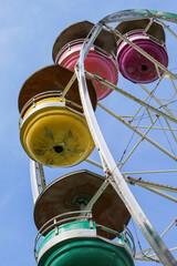 Closeup of Ferris Wheel with Colorful Passenger Cars at Amusement Park