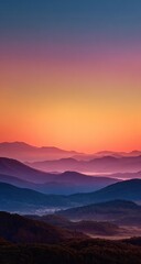 Obraz premium Misty mountain ranges bathed in a vibrant sunrise. Layered hills and valleys painted in hues of peach, orange, and violet, with a soft, ethereal light