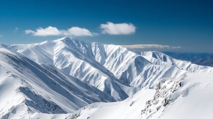view from summit showing endless mountain ridges under blue sky