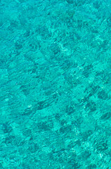 A view of crystal clear turquoise sea water that is soothing to the eyes. Background and pattern for design. Photo taken at Atauro Beach, Timor Leste.