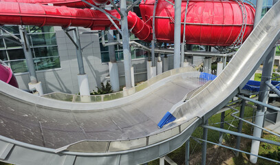 Water slide with curved design at a recreational facility surrounded by vibrant colors