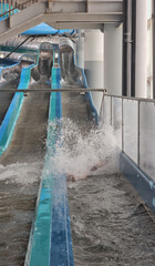 Enjoying a thrilling ride down a water slide at an indoor water park