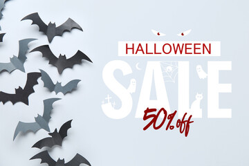 Paper bats for Halloween party on grey background