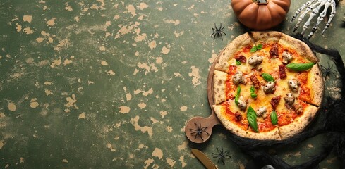 Tasty Halloween pizza and decorations on grunge background with space for text