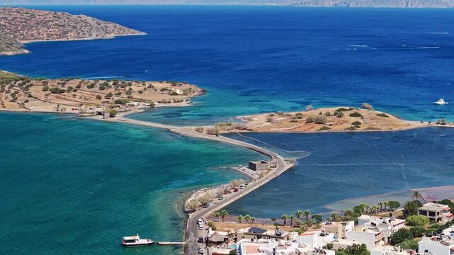 High angle view of the causeway, windmills, and Aegean Sea at Elounda, Crete.