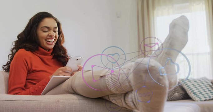 woman on sofa tapping phone, generating semi-transparent social media icons linking notifications