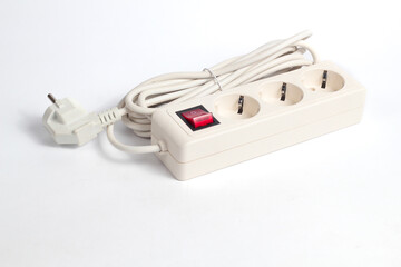 white extension cord featuring a power strip with three outlets and a red switch, set against a...