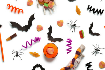 Composition with sweet jelly candies and Halloween decorations on light background