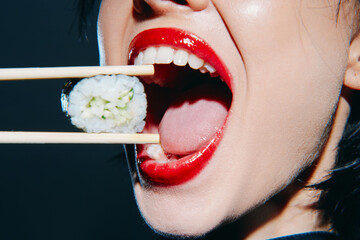 Close-up of a woman with bold red lips using chopsticks to hold sushi, showcasing a joyful eating experience in a vibrant style.
