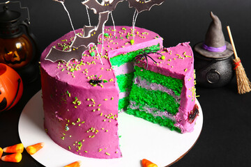 Tasty cake with Halloween decorations on black background, closeup